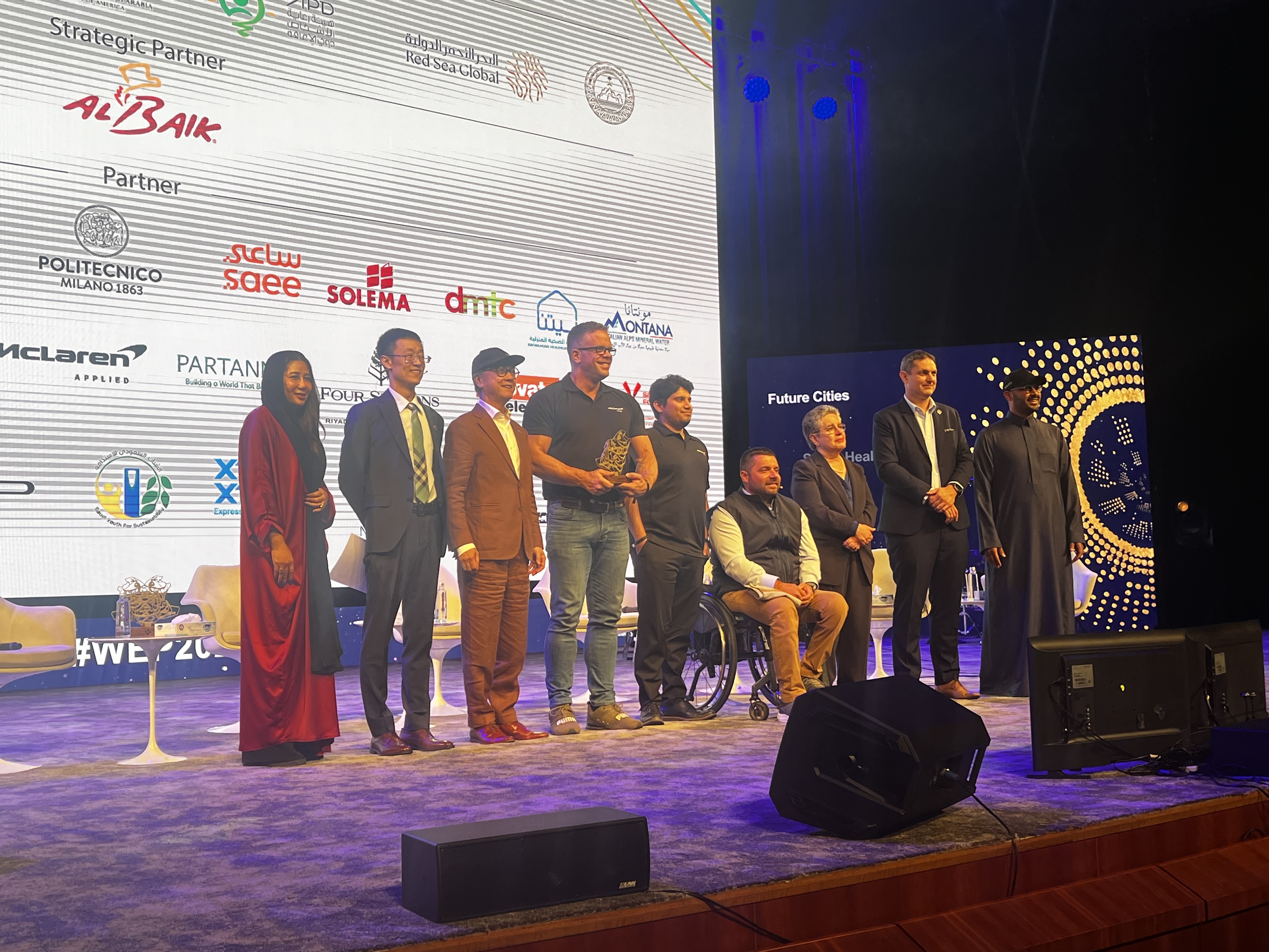 On stage receiving an award at an industry conference
